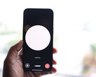 Hand hält Smartphone mit Sprachassistent-Oberfläche auf dem Bildschirm