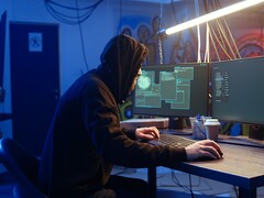 Ein Angreifer im TeamPCP-Stil führt an einer Workstation mit zwei Monitoren eine Supply-Chain-Attacke aus