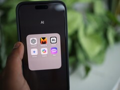 Hand hält ein Smartphone mit einem Ordner voller KI-Apps auf dem Bildschirm