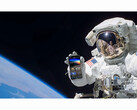 A promotional image for the free NASA+ service featuring an astronaut holding a smartphone with the NASA+ app open in space. (Image Source: NASA)