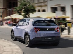 A rear shot of the Nio Firefly taking a sharp turn on asphalt