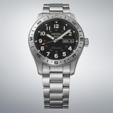 Seiko 5 Sports HDB006 automatic field watch with black dial, compass bezel, and stainless steel bracelet.